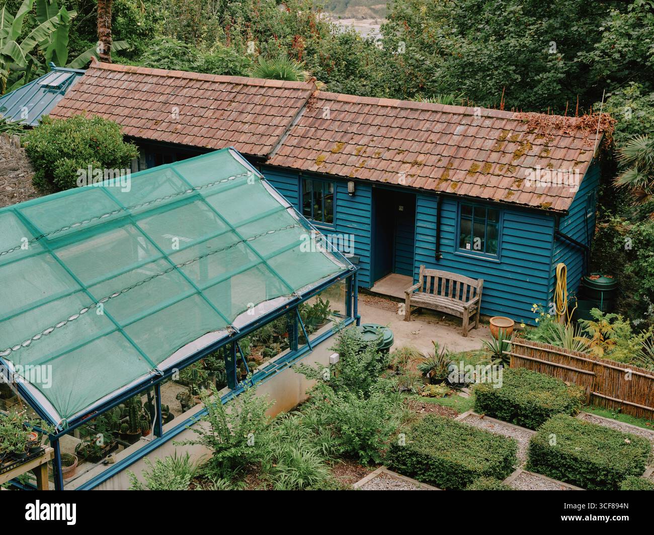 Greenhouses and sheds at Overbeck's Garden at Sharpitor Edwardian subtropical Grade II registered garden at Sharpitor, Salcombe, Devon, England UK Stock Photo