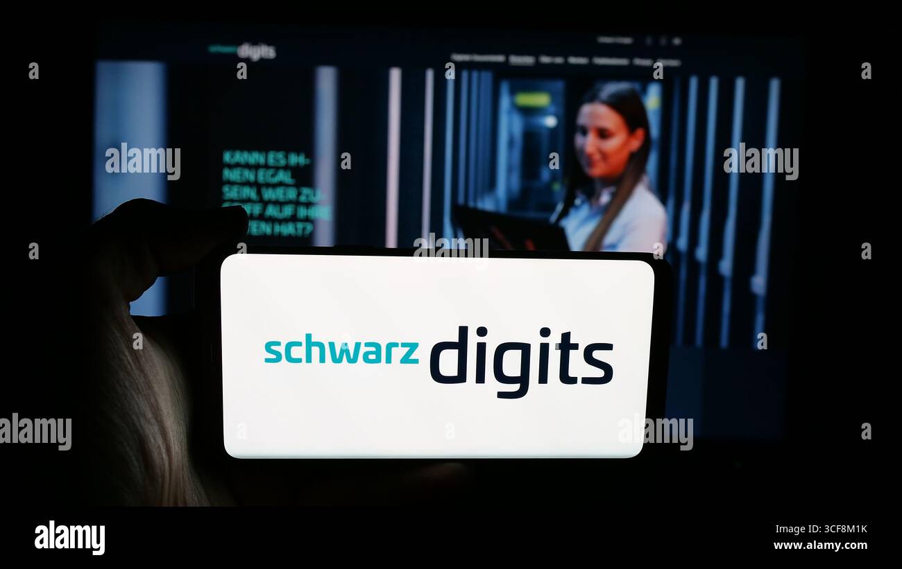 Stuttgart, Germany - 08-07-2025: Person holding cellphone with logo of German IT company Schwarz Digits KG on screen in front of webpage. Stock Photo
