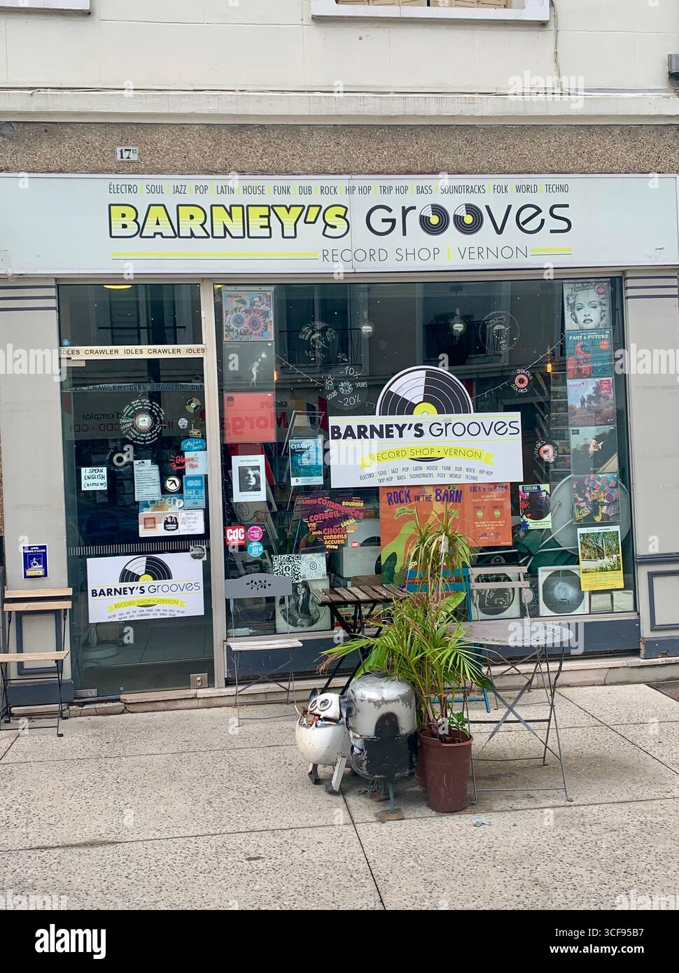 Vernon France shops shop tourists village town locals people cobbles cobbled restaurant eating food old style houses polar bear artwork sign signs - Smartphone Captured Stock Image