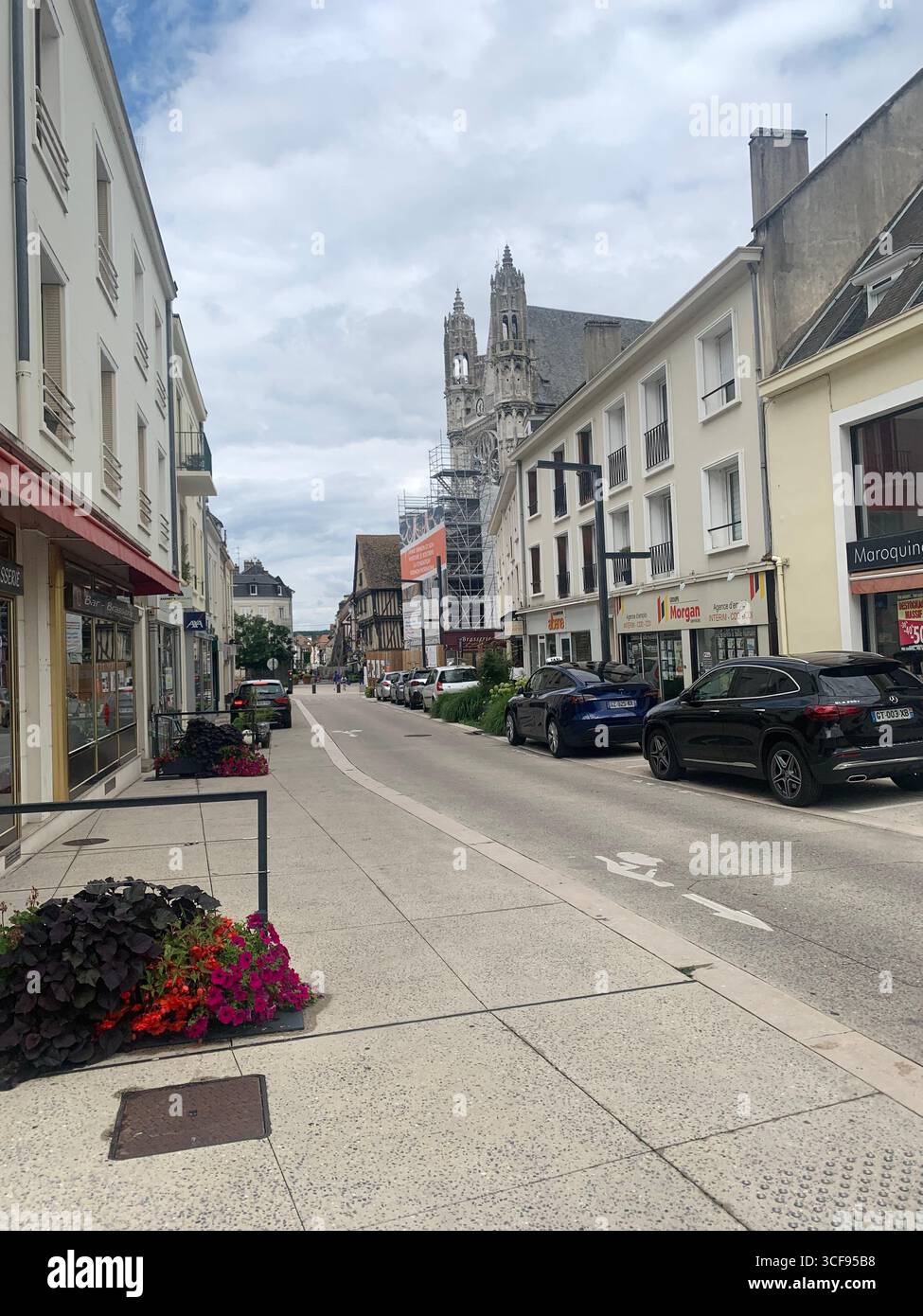 Vernon France shops shop tourists village town locals people cobbles cobbled restaurant eating food old style houses polar bear artwork sign signs - Smartphone Captured Stock Image