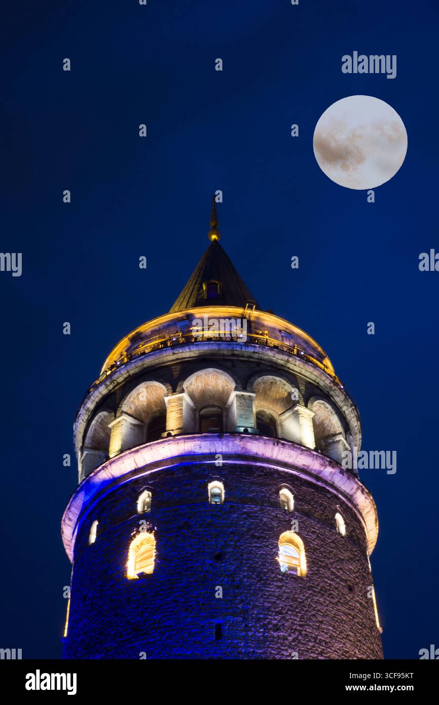 A vertical shot of the Galata Tower in Istanbul, Turkey, at night with ...