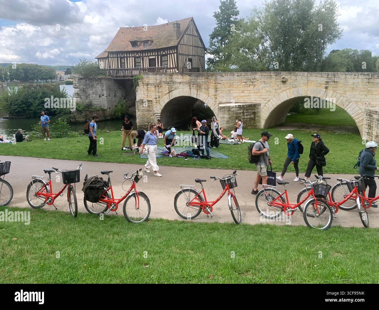 Park Promenade people place water  Berges De La Seine bike cycle tour tourists sign signs zebra crossing bridge arch arches stop sign artwork art - Smartphone Captured Stock Image