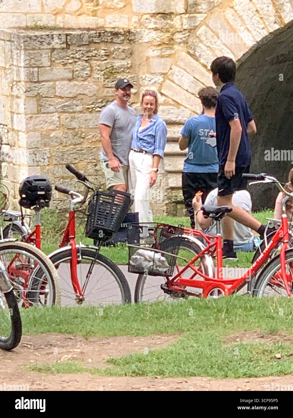 Park Promenade people place water  Berges De La Seine bike cycle tour tourists sign signs zebra crossing bridge arch arches stop sign artwork art - Smartphone Captured Stock Image