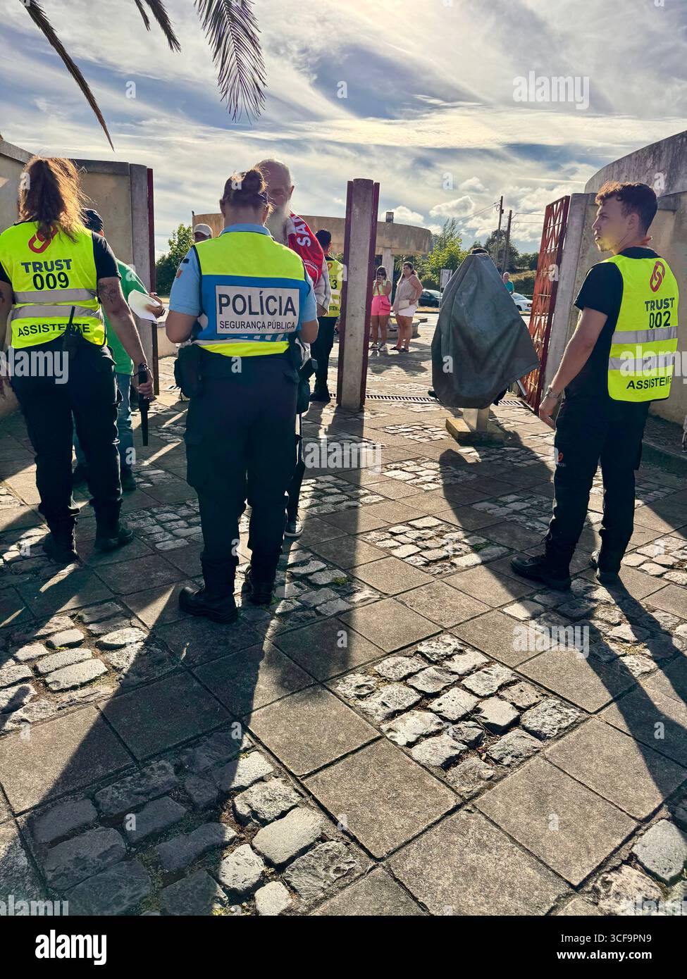 Police officers and stewards manage crowd entry at Estádio de São Miguel before the UEFA Conference League play-off between Santa Clara and Shamrock R - Smartphone Captured Stock Image