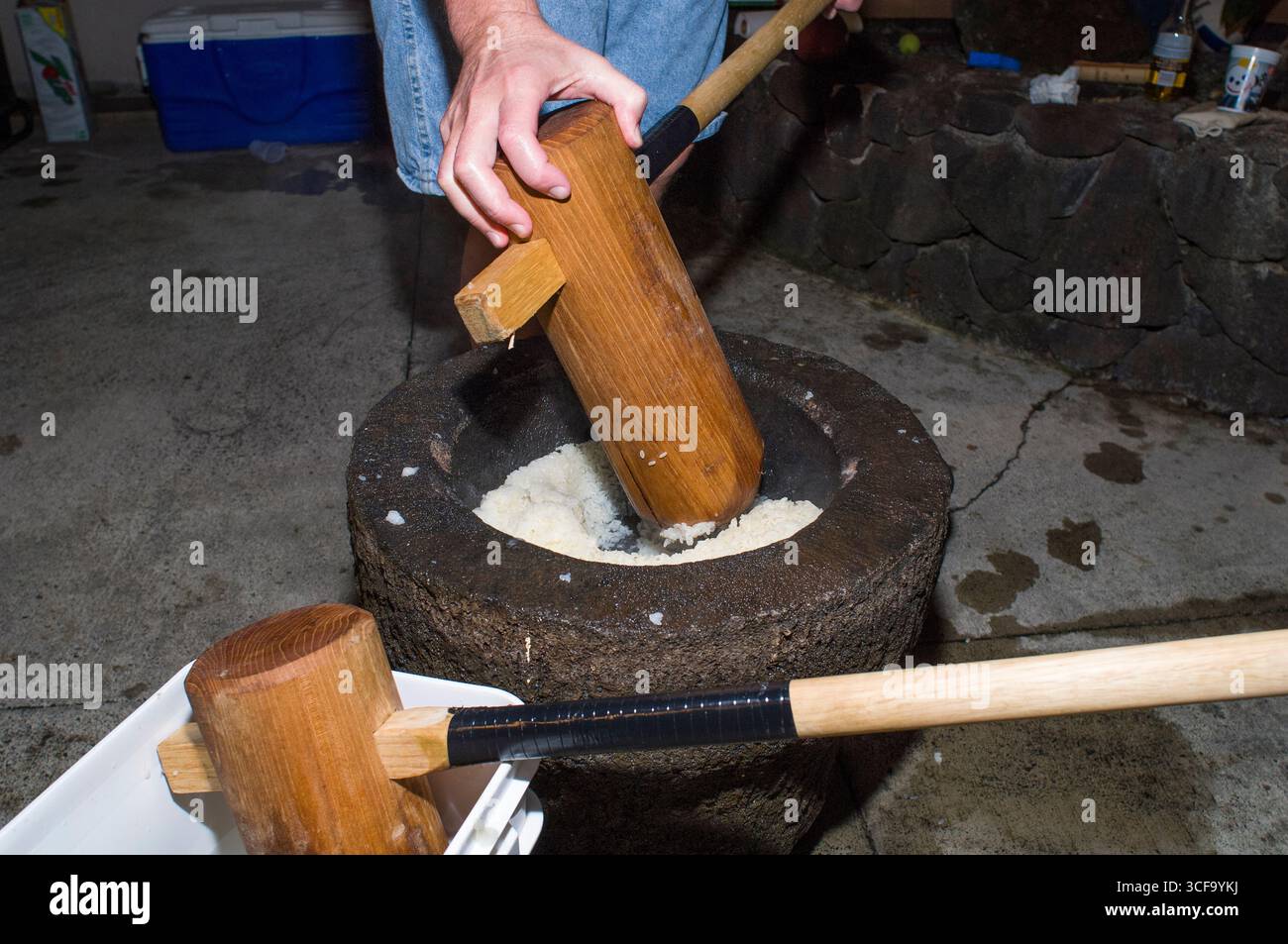 Stones In Rce Man using wooden mallet called a kine to smash rice into stone mortar ...