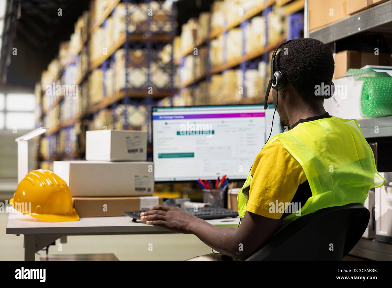 Warehouse operator assisting clients order hi-res stock photography and ...