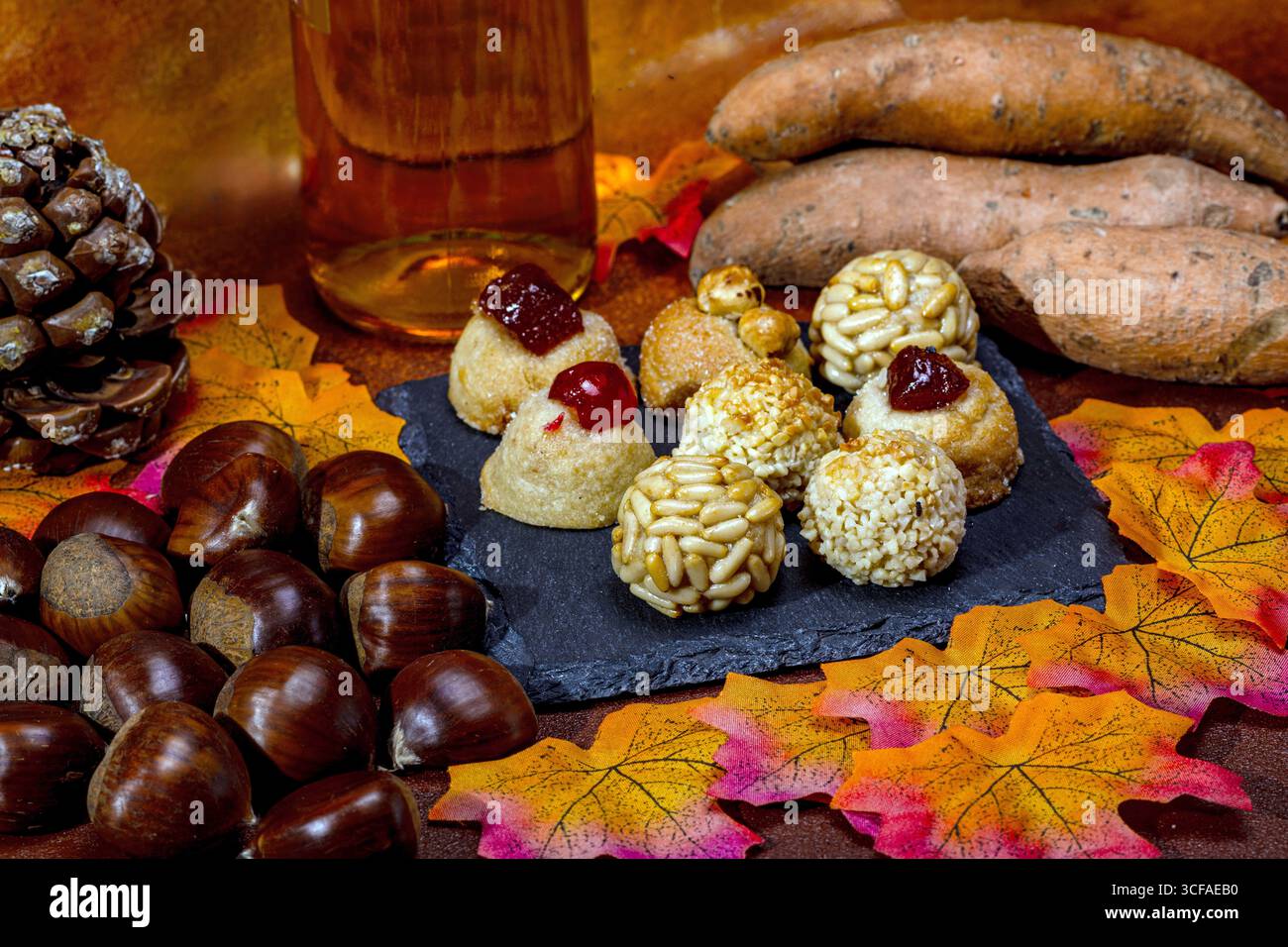 Celebrating castanyada with traditional panellets, chestnuts, sweet potatoes, and muscatel wine Stock Photo