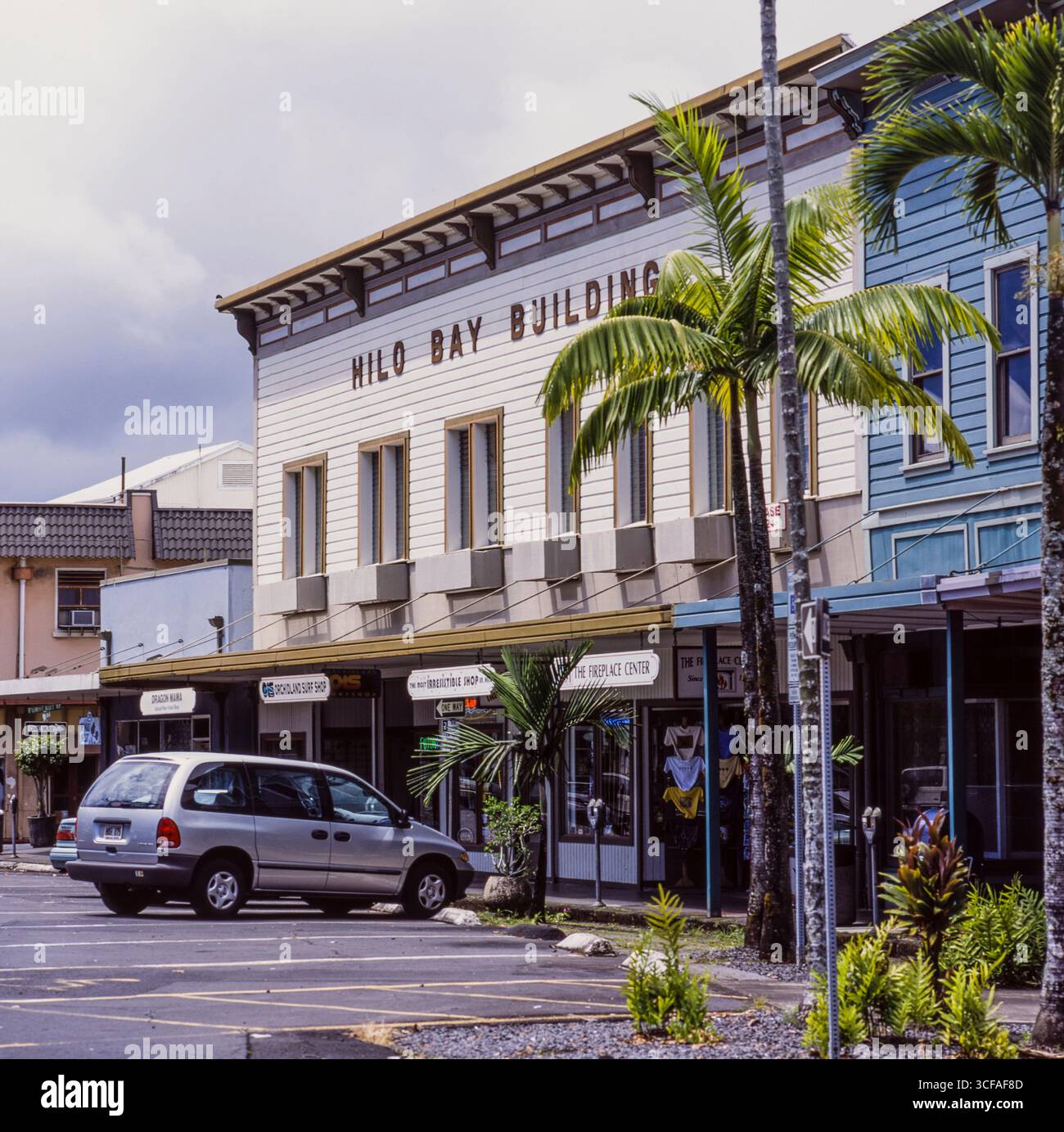 Hilo Bay building and small store fronts line the street. Many downtown ...