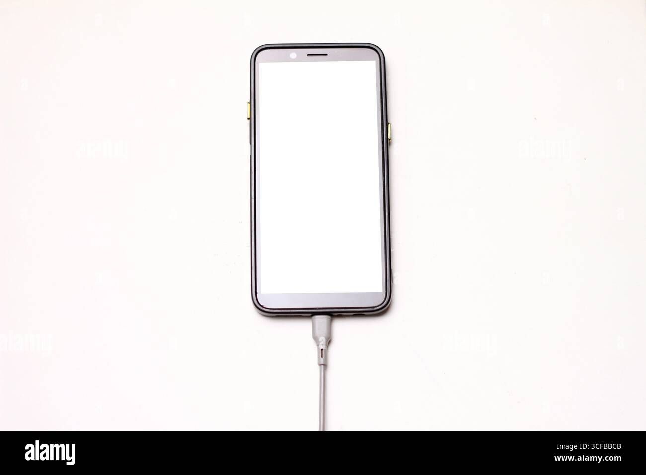 Smartphone Connected to USB Cable with White Background. Stock Photo