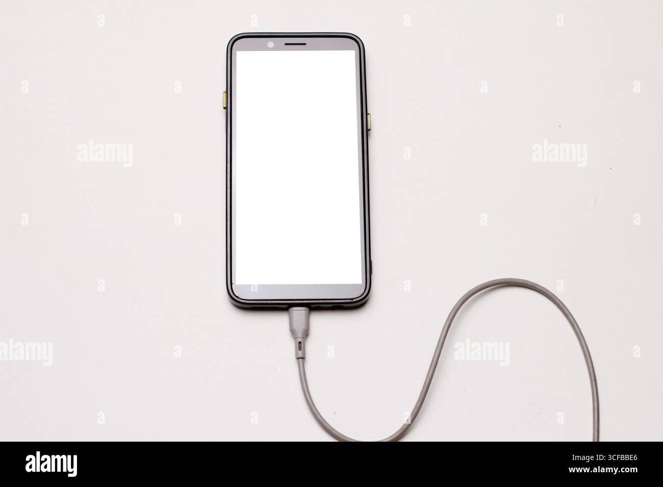 Smartphone Connected to USB Cable with White Background. Stock Photo