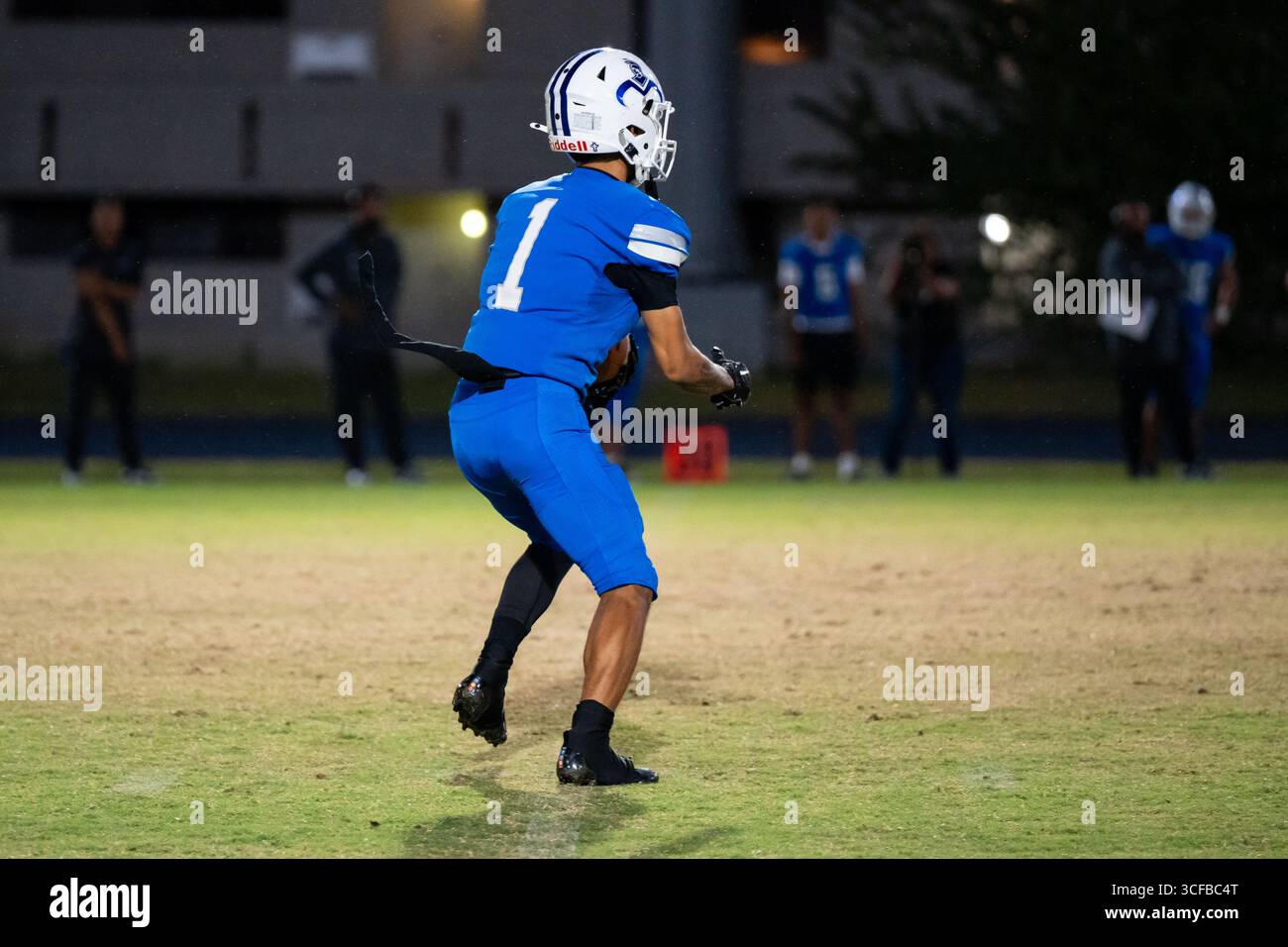 American Football Game Moanalua vs Campbell. Played at night on natural grass field. Rivalry season opener. Stock Photo