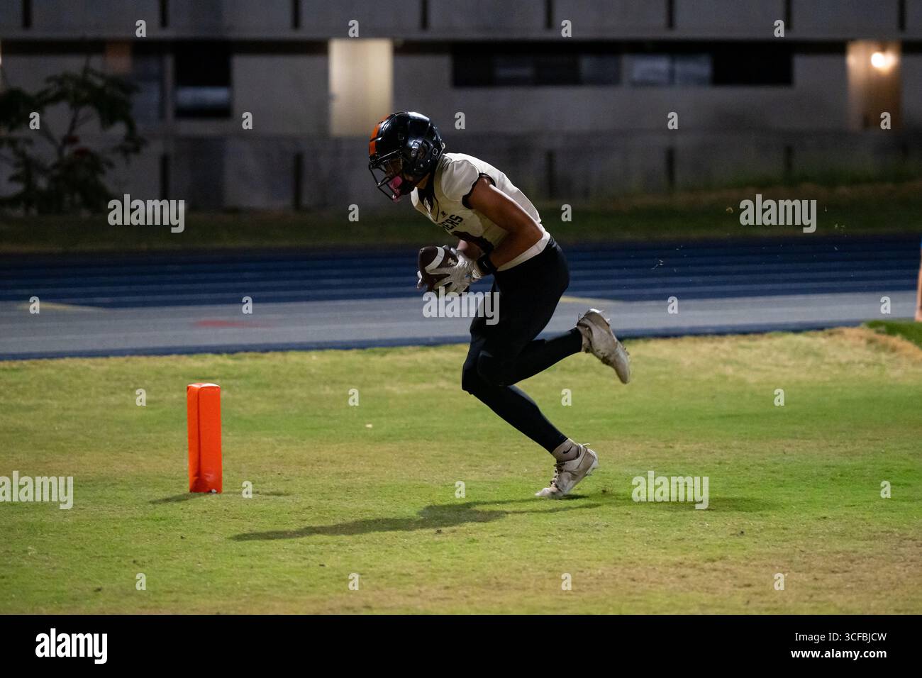 American Football Game Moanalua vs Campbell. Played at night on natural grass field. Rivalry season opener. Stock Photo