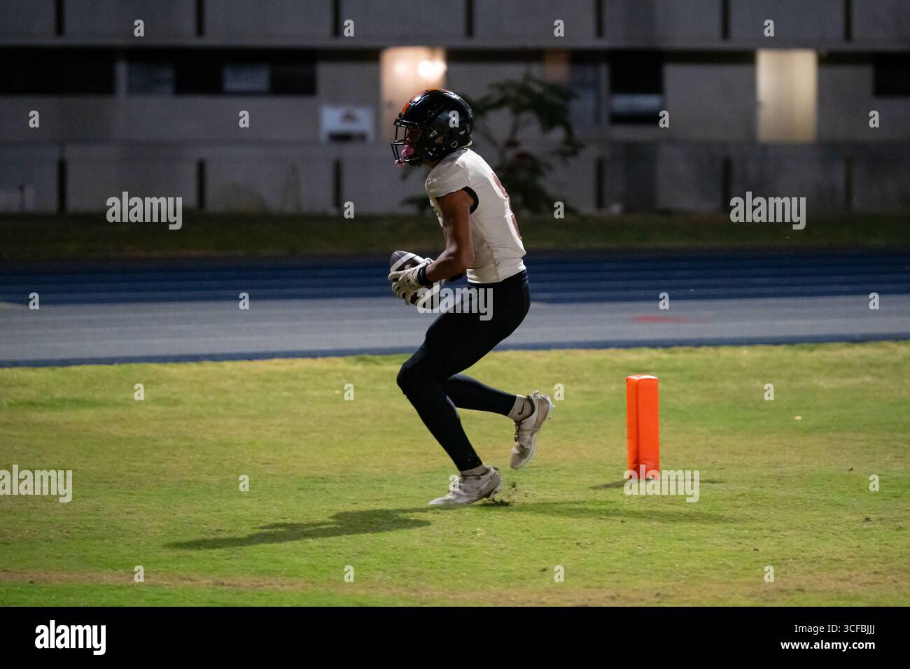 American Football Game Moanalua vs Campbell. Played at night on natural grass field. Rivalry season opener. Stock Photo