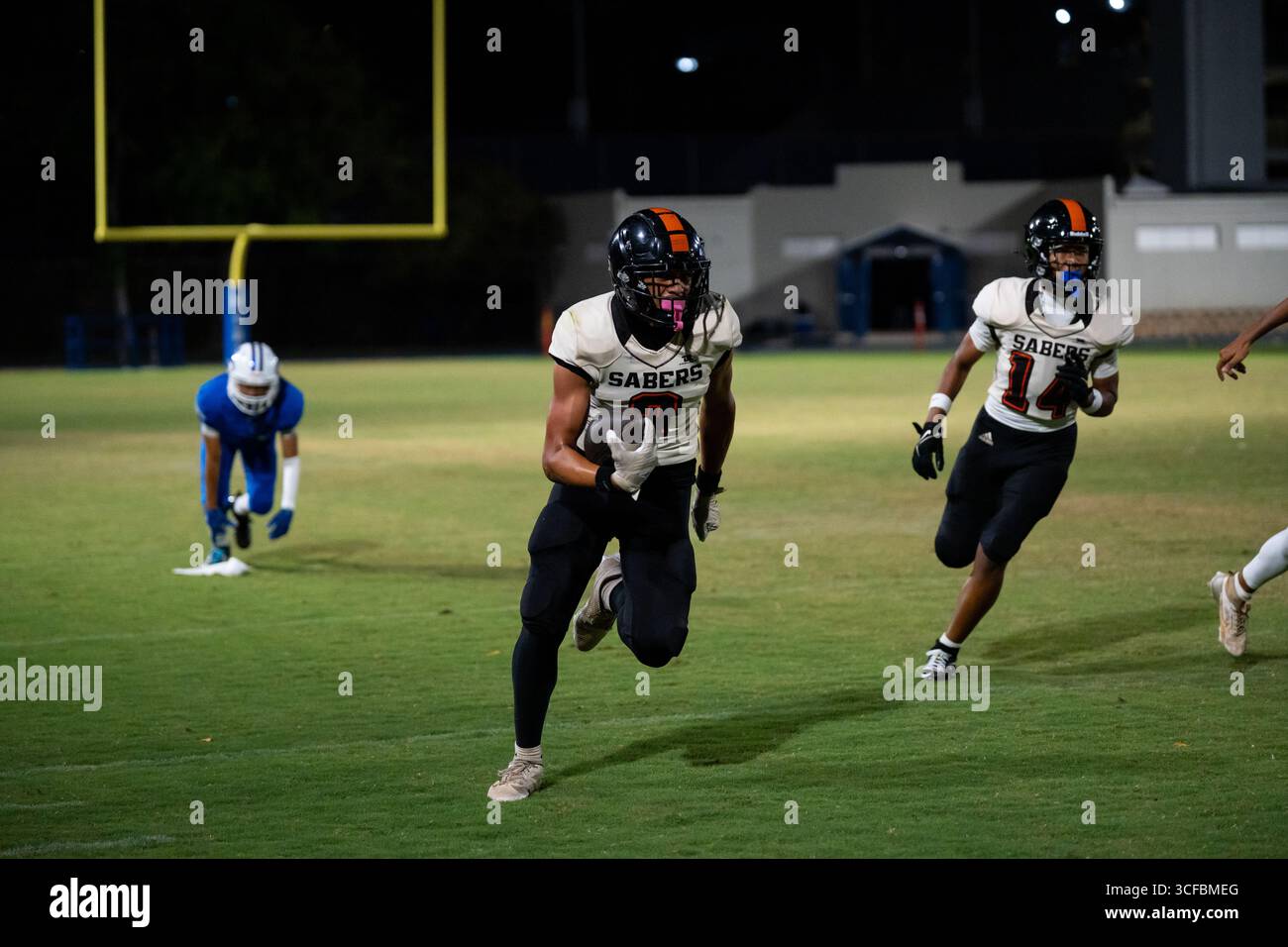 American Football Game Moanalua vs Campbell. Played at night on natural grass field. Rivalry season opener. Stock Photo
