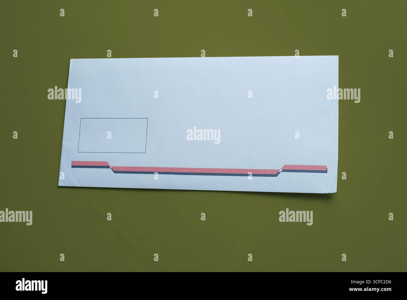 White envelope isolated on green background. Stock Photo
