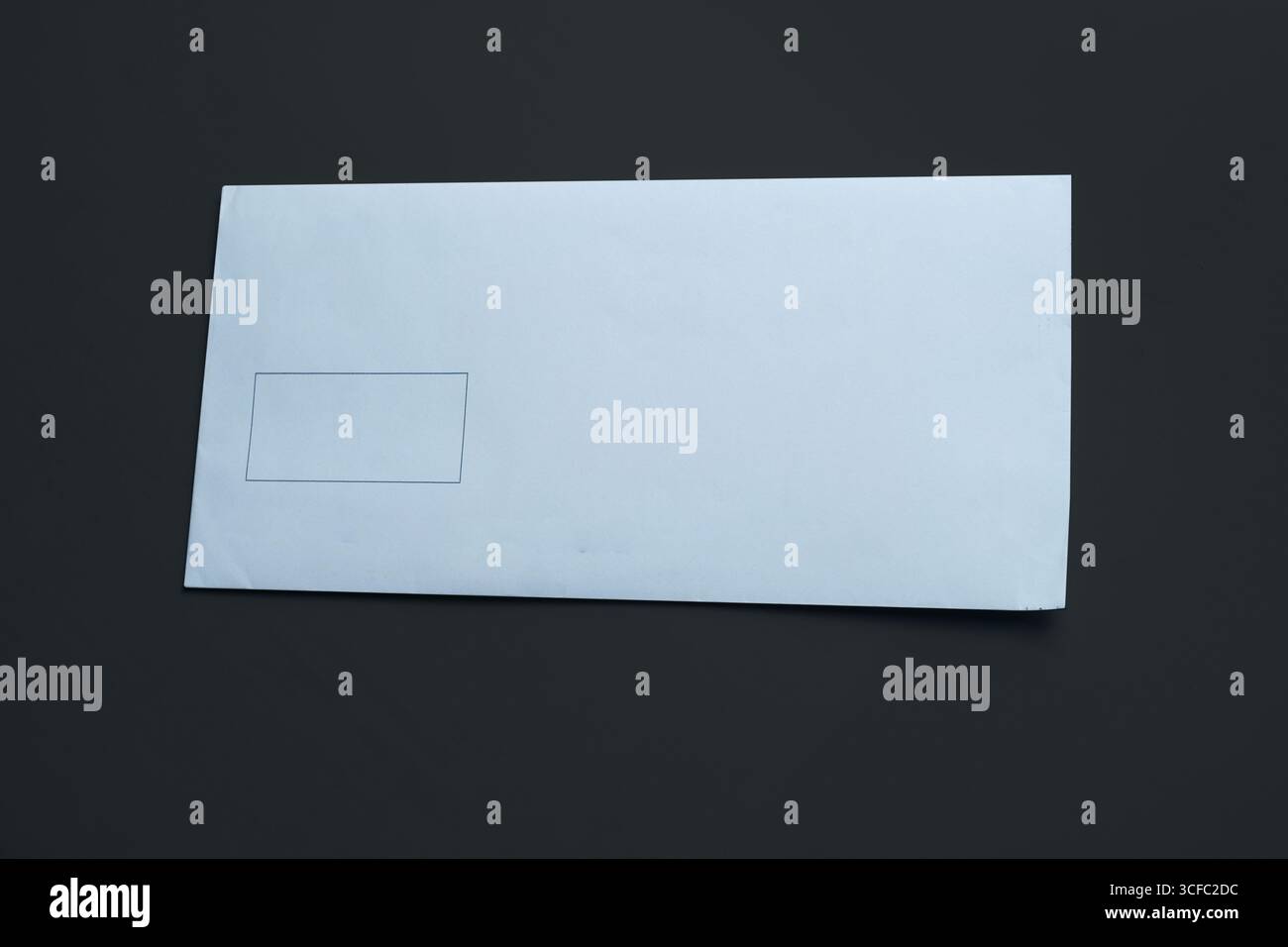 Blank white envelope isolated on black background. Stock Photo