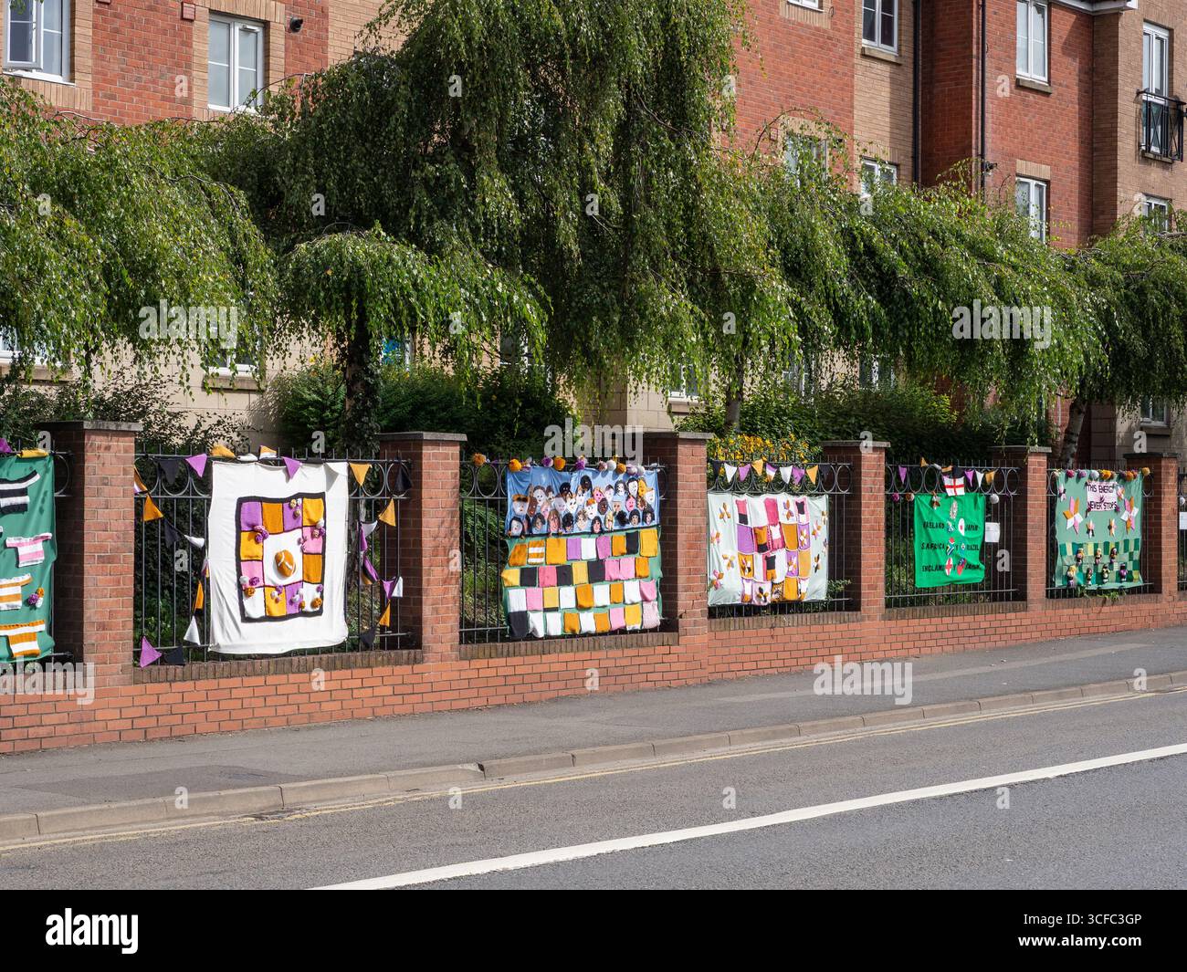 Knitted decorations prepared by local groups to celebrate the Women's Rugby World Cup 2025 outside the Railway Station, Northampton, UK Stock Photo