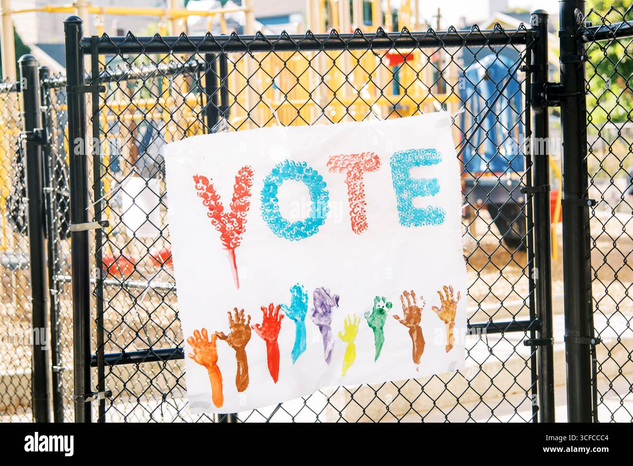 Colorful "VOTE" sign with children’s handprints Stock Photo