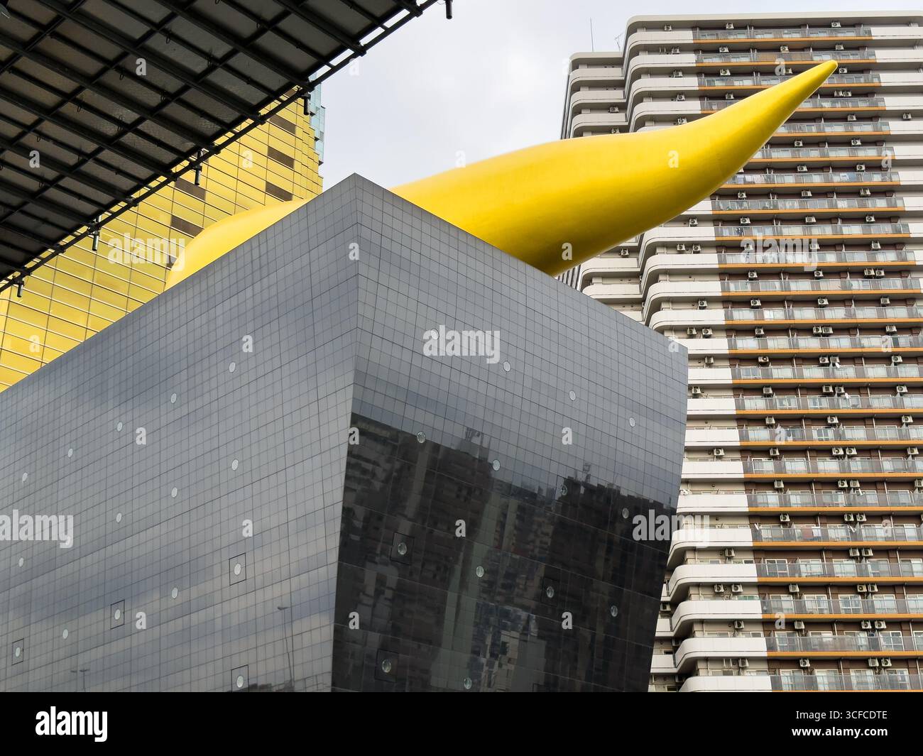 Asahi Breweries in Sumida, Tokyo, Japan. Asahi Beer Hall with Asahi Flame on the east bank of the Sumida River. - Smartphone Captured Stock Image