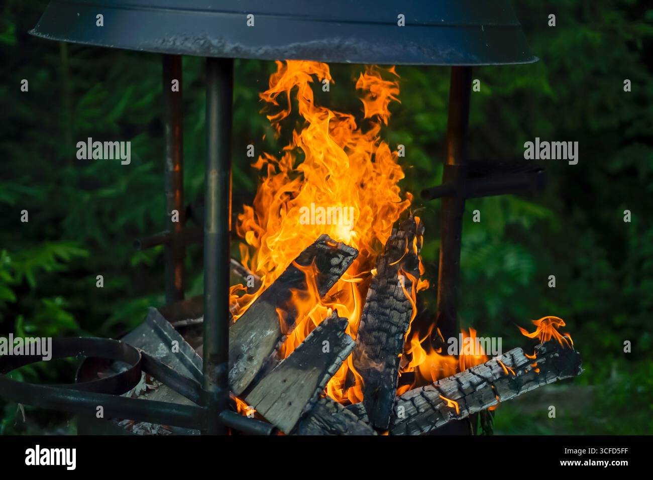 Burning Firewood in an Outdoor Fire Pit Stock Photo