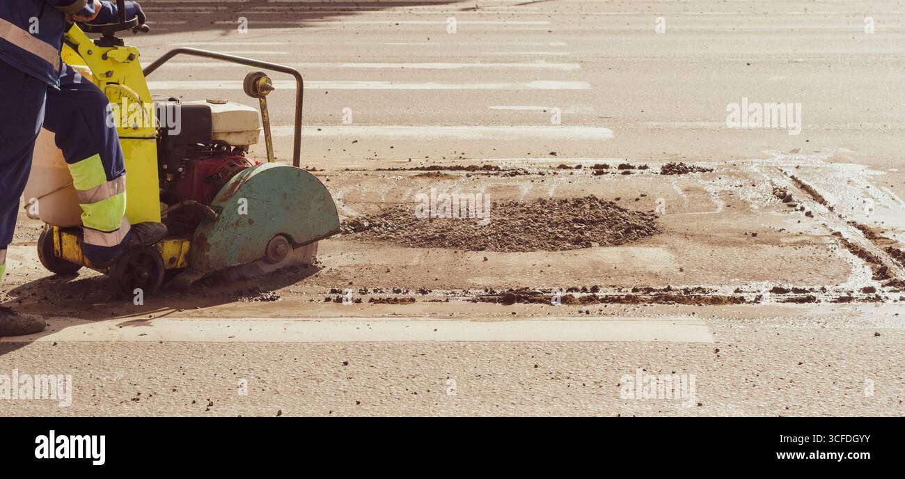 Lorry Cuting Worker with Asphalt Road Cutting Machine cuts asphalt , banner Stock ...