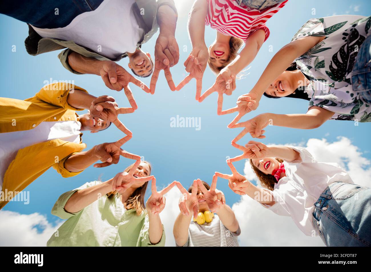 Young group of diverse friends outdoors bonding over a sunny day ...
