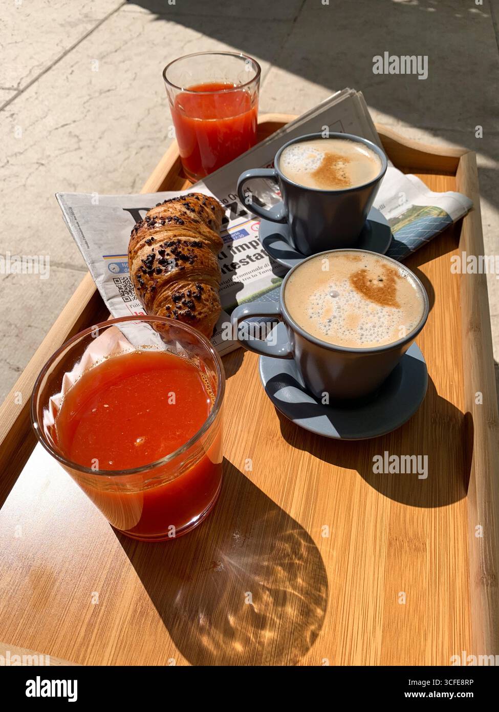 Traditional Italian breakfast. Fresh croissants, cappuccino and orange juice on a wooden table. European cuisine and pastries. Morning meal. - Smartphone Captured Stock Image