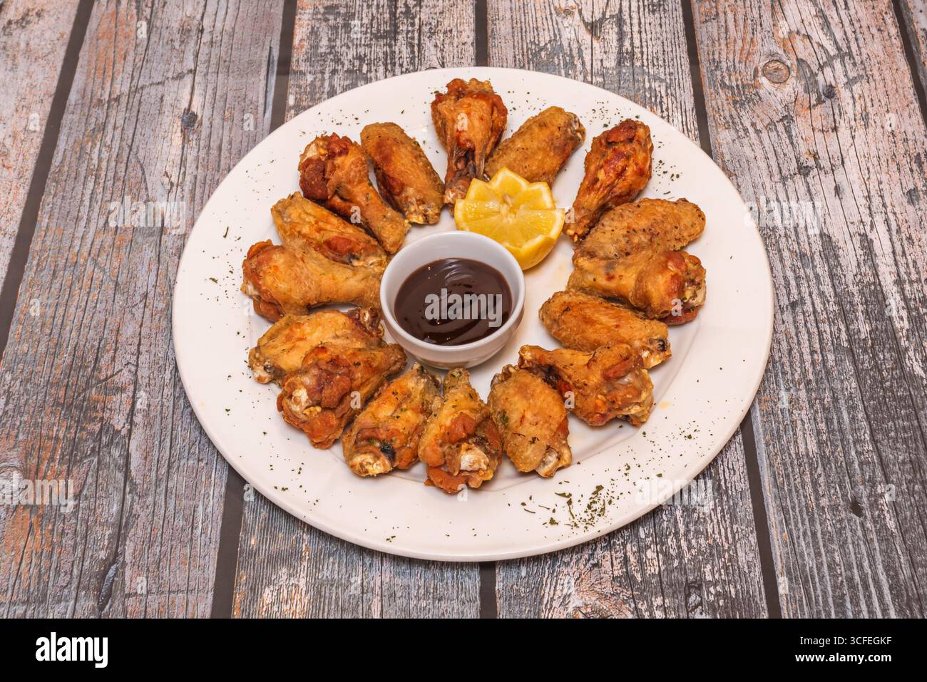 Fried wings coated in chipotle and coffee sauce, deep smoky flavors with an earthy touch Stock Photo