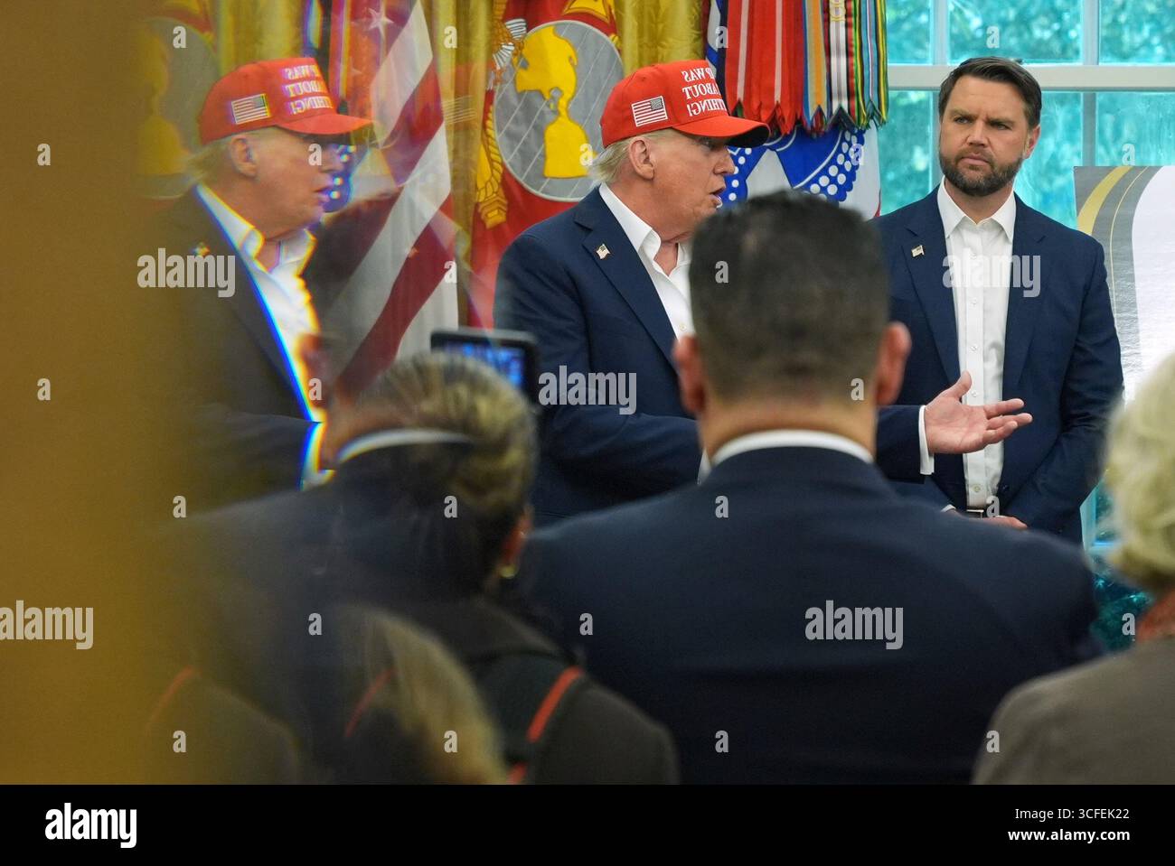 President Donald Trump, left, pictured in reflection, speaks as Vice ...