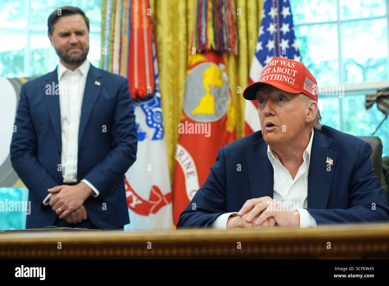 President Donald Trump speaks as Vice President JD Vance listens in the ...