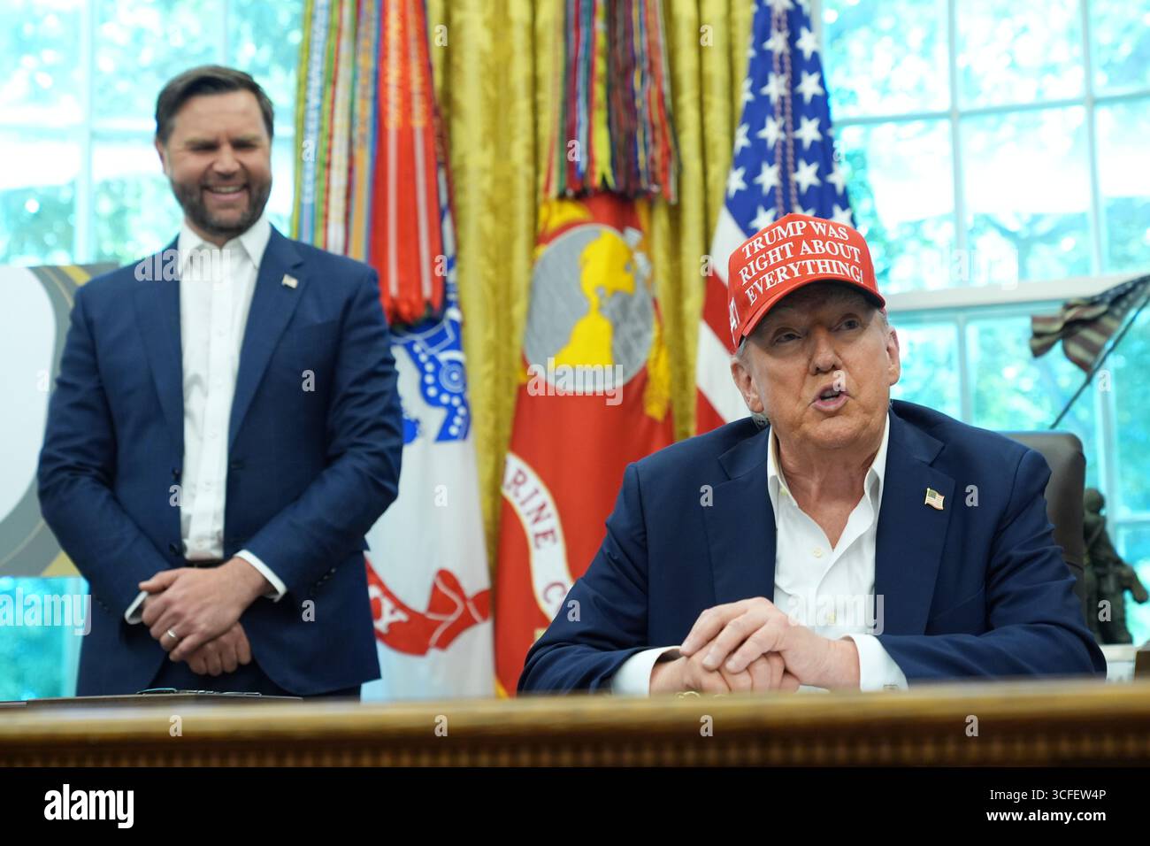 President Donald Trump speaks as Vice President JD Vance listens in the ...