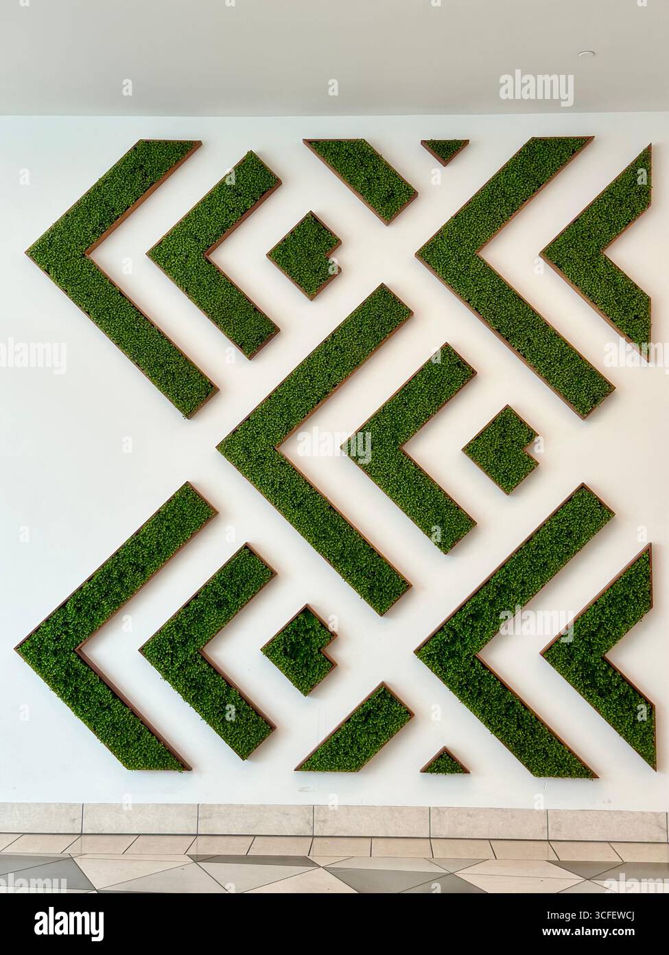 Geometric green wall art installation with abstract design - Smartphone Captured Stock Image