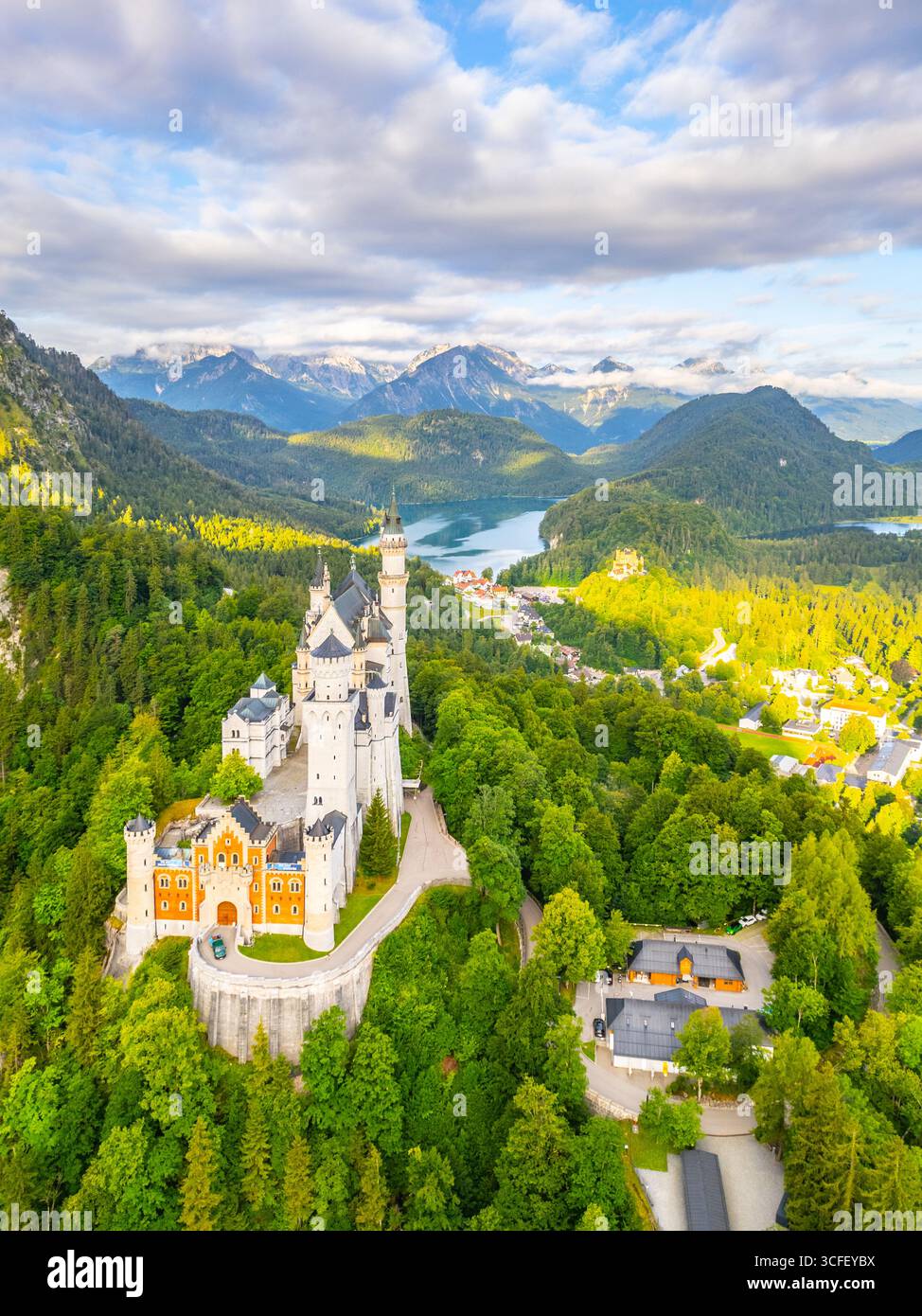 Neuschwanstein Castle, nestled in the Bavarian Alps, overlooks lush ...