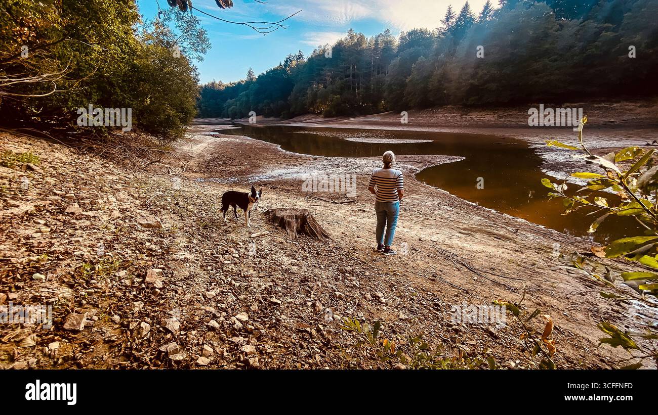Ardingly Reservoir female looking onto a barren landscape in Sussex. 22nd Aug 2025, Dry reservoir after the hottest summer on record in the UK. - Smartphone Captured Stock Image