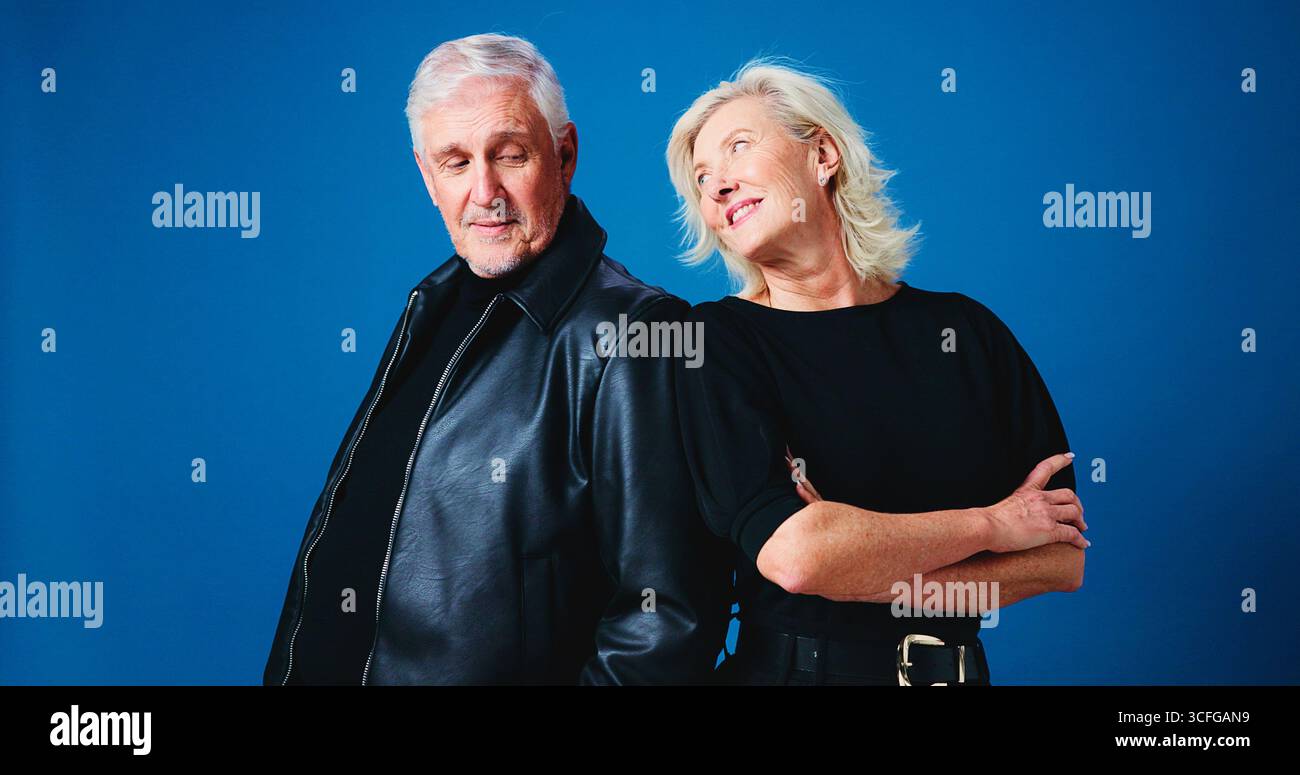 Fashion, happy and senior couple in studio for trendy outfit, cool clothes and pose together. Marriage, space and mature man and woman with attitude Stock Photo