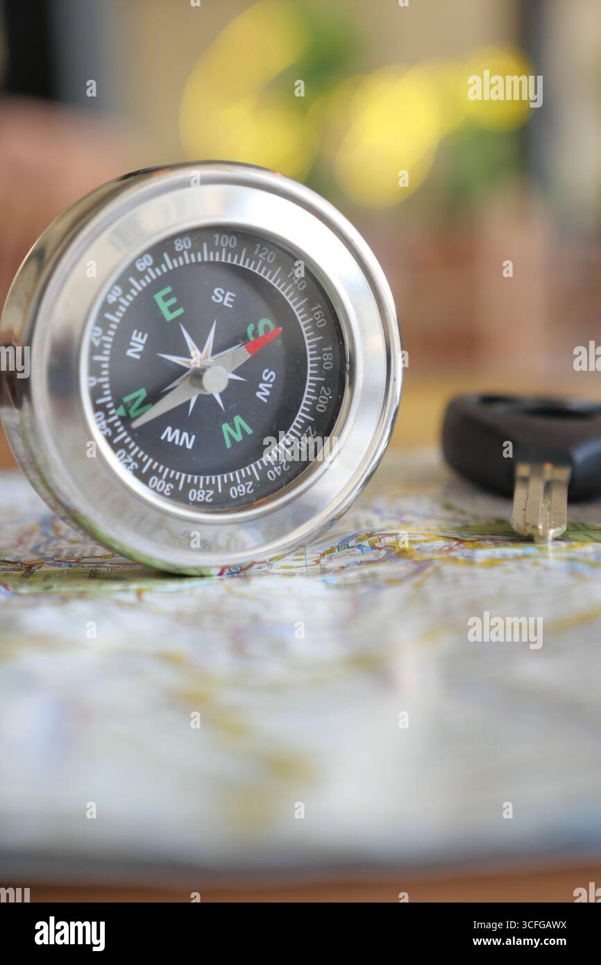 Using a compass to navigate a map on a table Stock Photo - Alamy