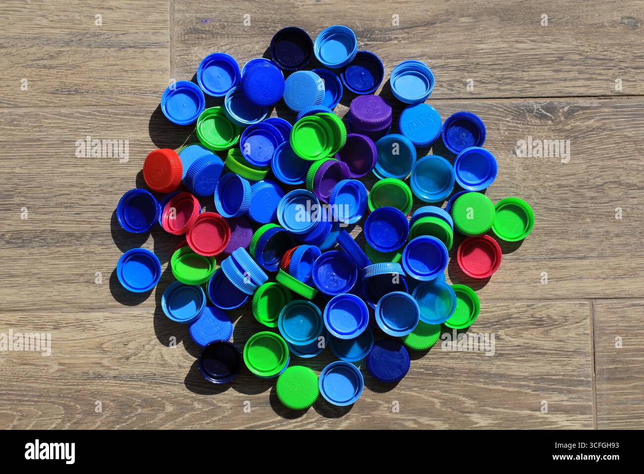 Different colored plastic water bottle caps. Colored plastic recycling ...