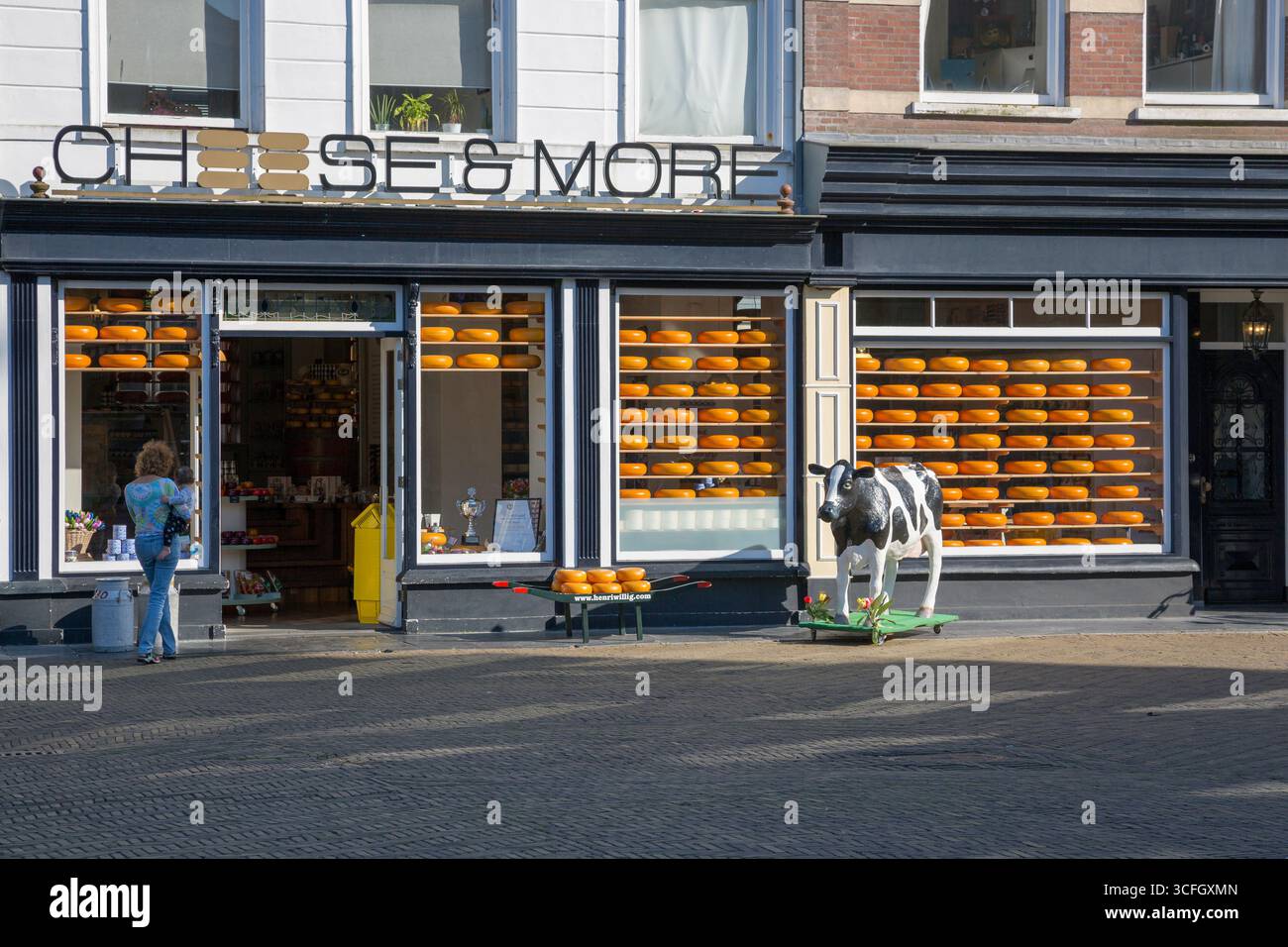 Delft, Netherlands - July 03, 2018: Dutch cheese shop on the Main Market Square in front of the Delft City Hall Stock Photo