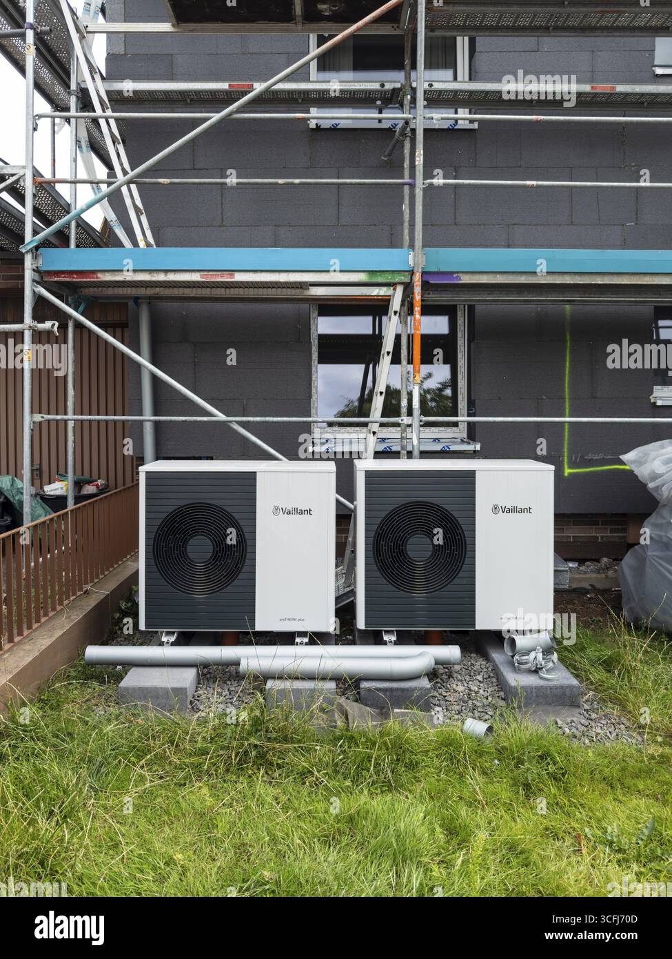 Two heat pumps in the front garden of an apartment block, insulation ...