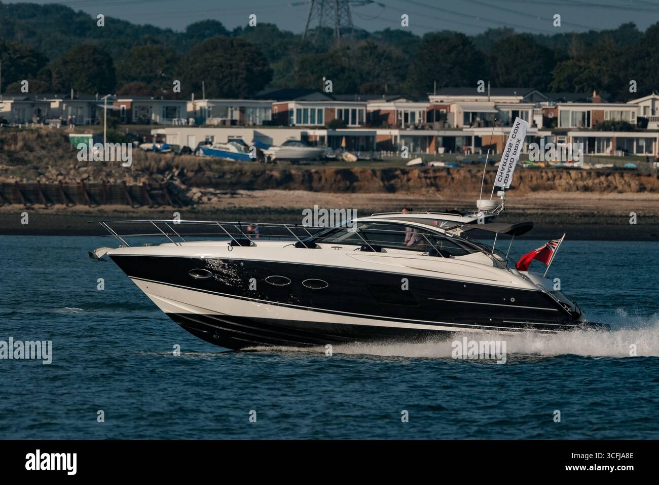 Grand prix charters motor yacht Princess V39 sailing at speed down the Solent Hampshire England on a sunny evening. Stock Photo