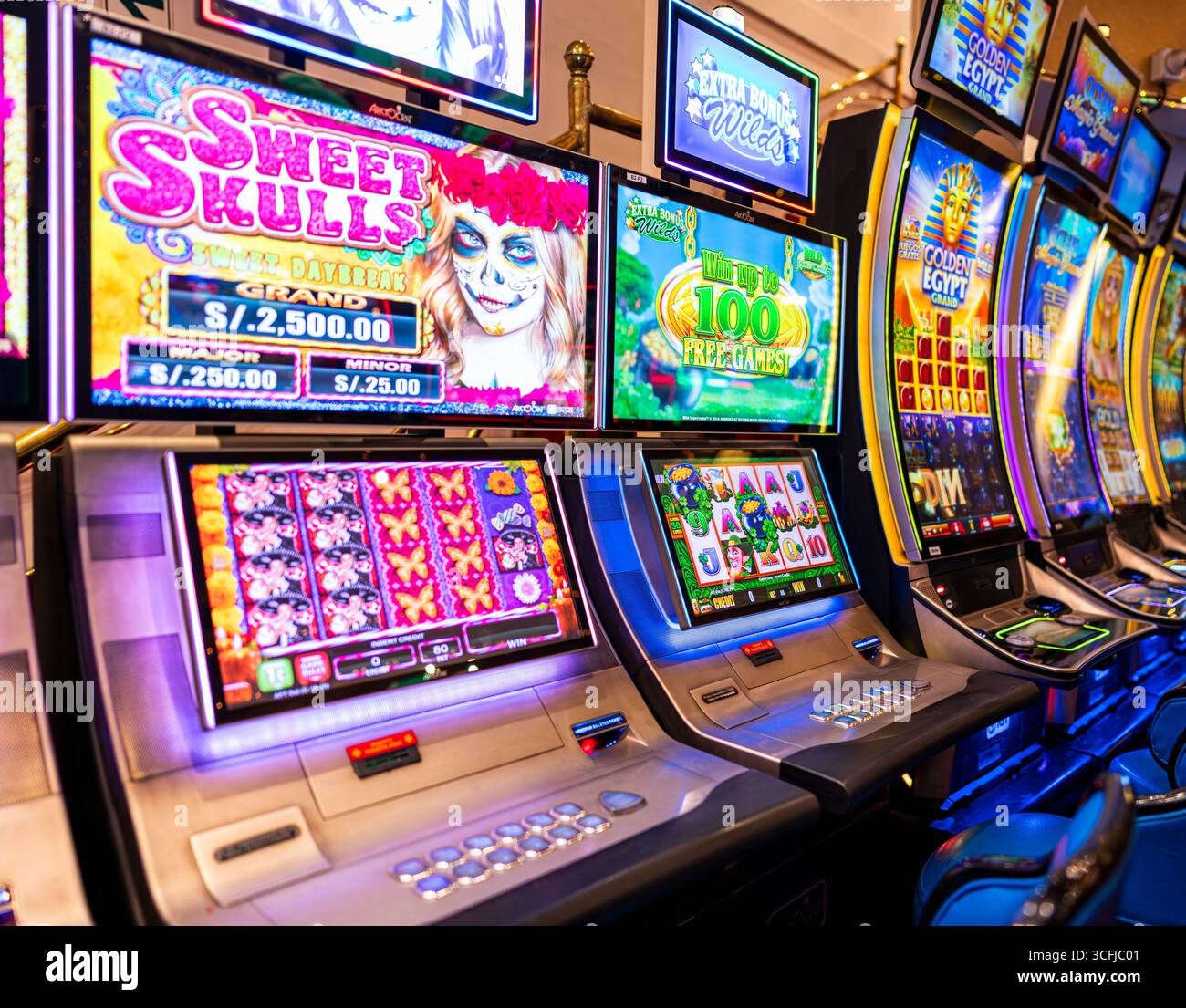 Sweet Skulls Day of the Dead themed slot machines in casino Stock Photo