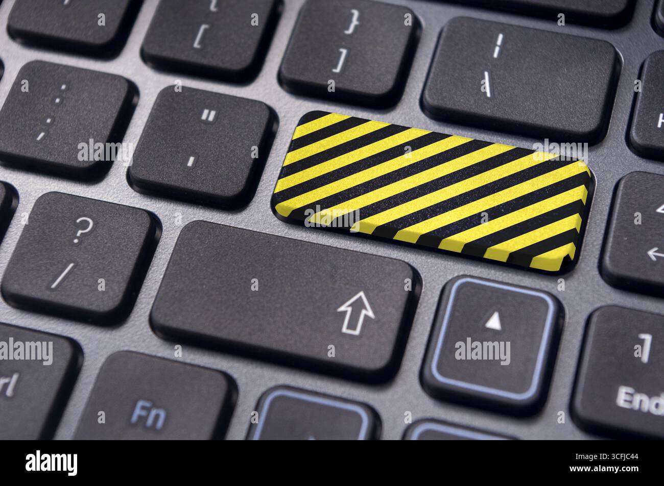 Yellow and black stripes on enter key of keyboard, for restricted websites of internet Stock Photo
