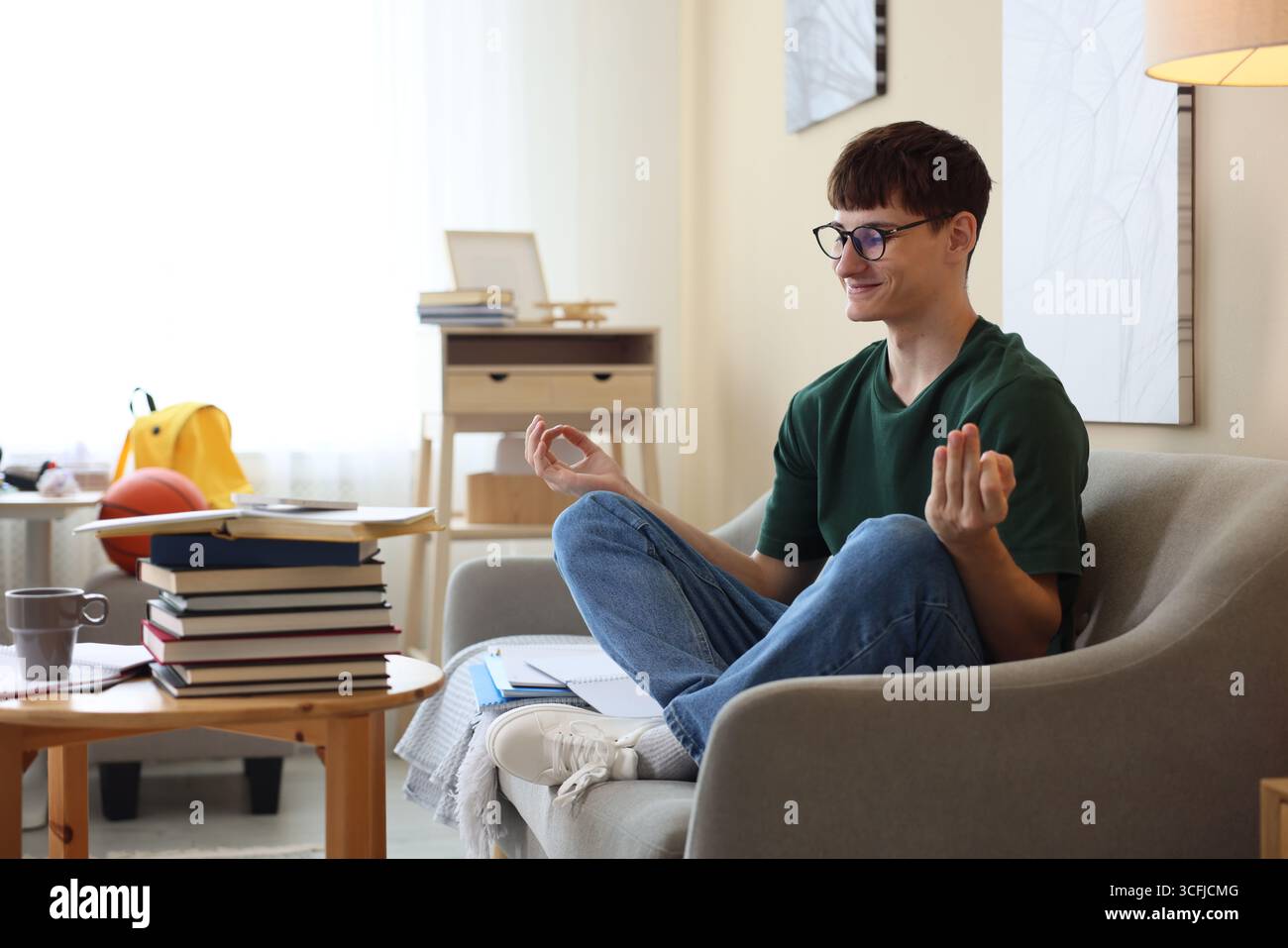 Student preparing for exam and meditating at home Stock Photo