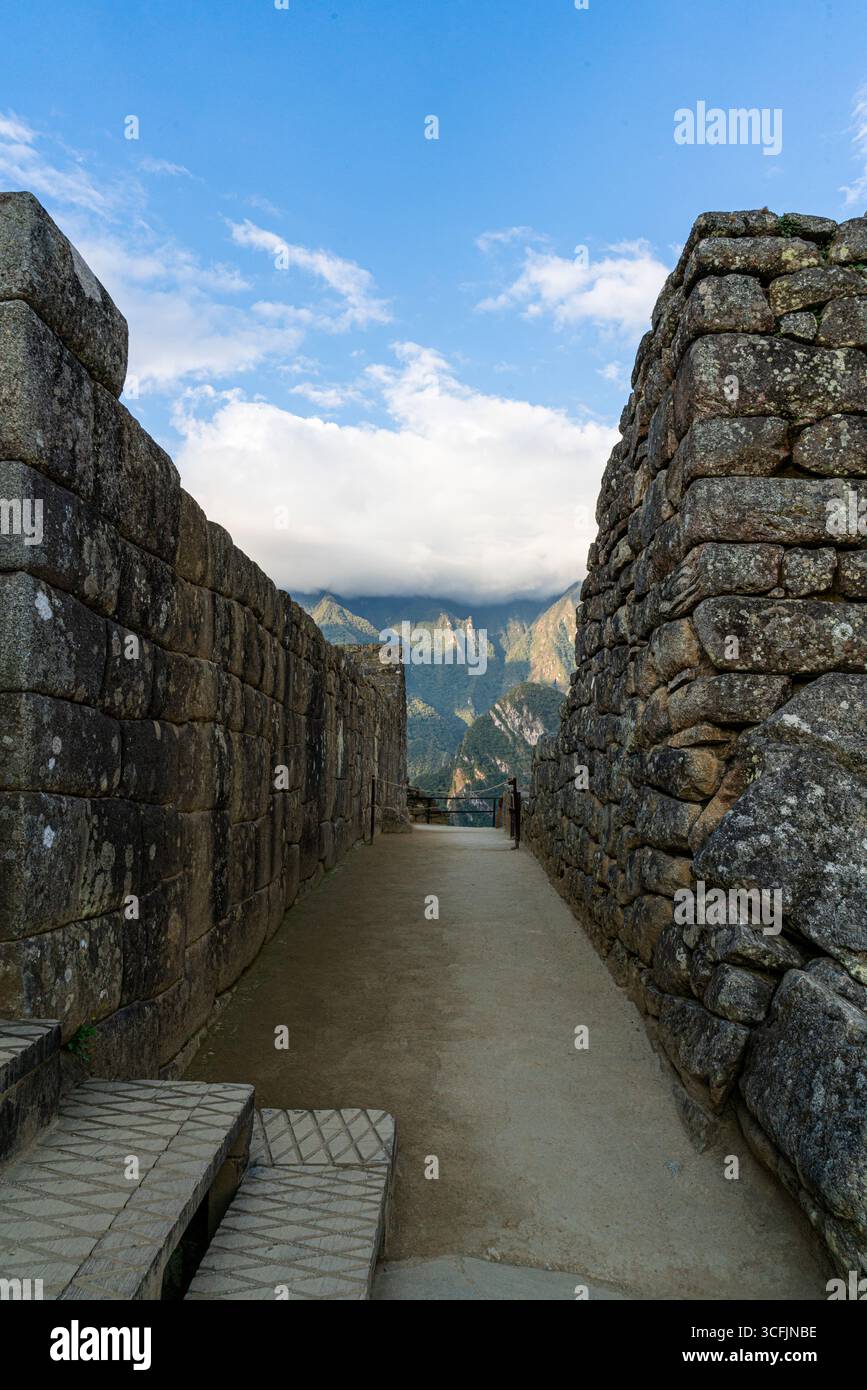 Inca stone corridor at Machu Picchu with ancient walls, mountain ...