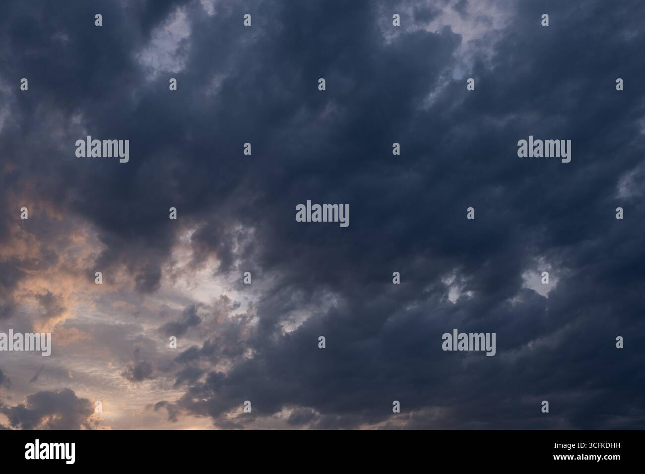 Dramatic sky with stormy clouds at sunset. Nature background Stock Photo