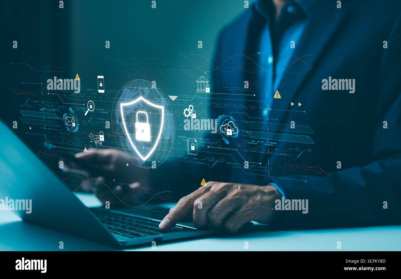 Cyber security data protection concept. Professional using a laptop with virtual protective shield, depicting online data security cyber protection Stock Photo