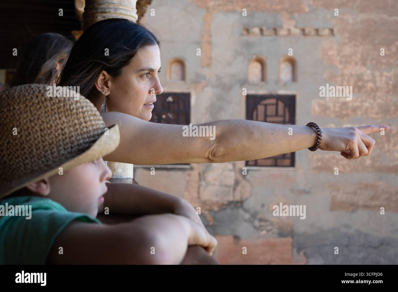 Mother pointing at something while sightseeing with children Stock Photo