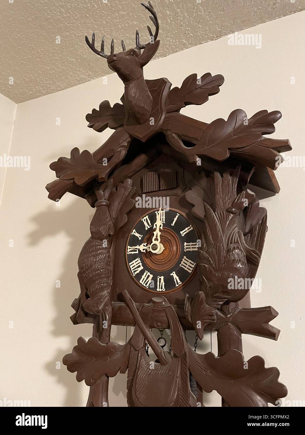 Close-up of a handcrafted cuckoo clock featuring a Majestic stag from West Germany, 1950s - Smartphone Captured Stock Image