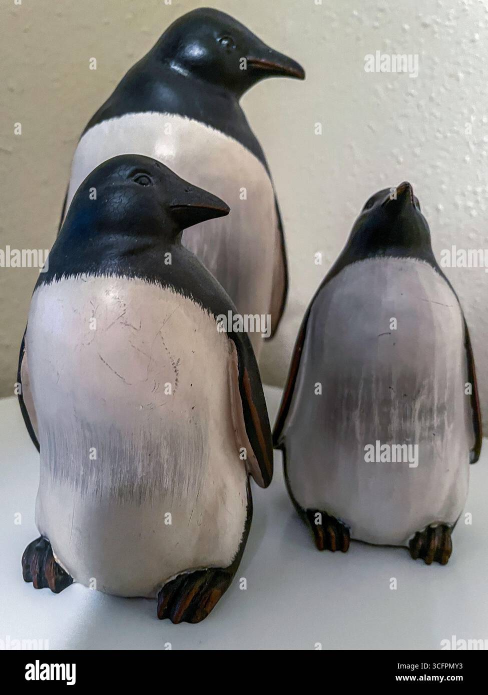 Cabinet with decorative penguin statues on top, USA, 2025, MT, USA - Smartphone Captured Stock Image