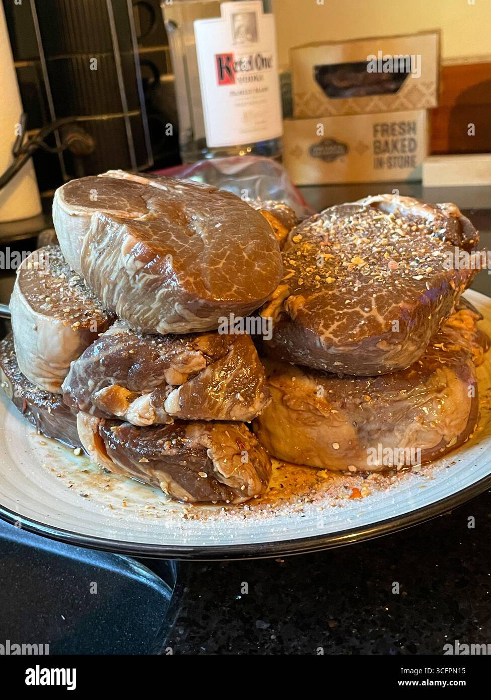 Still life of marinated fillet mignon steaks, prepped for grilling on a summer afternoon, 2025, United States - Smartphone Captured Stock Image
